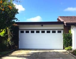 New white garage door installed on a residential home