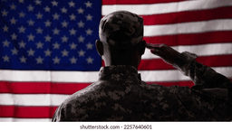 Military service member saluting the American flag