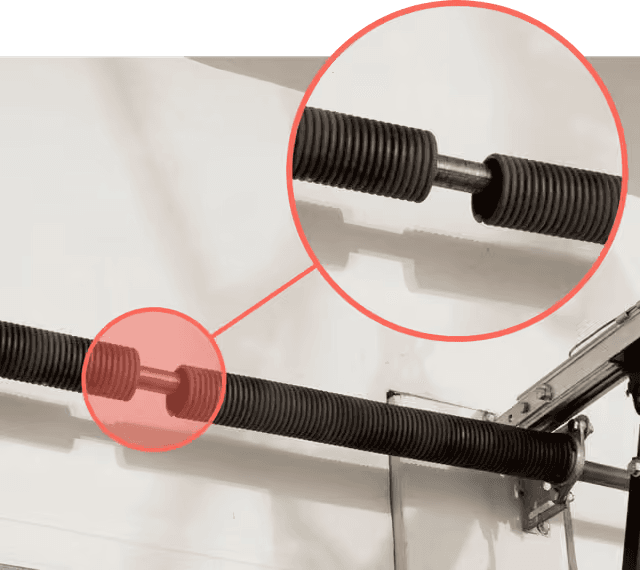 Broken garage door torsion spring with a visible gap — professional spring replacement needed